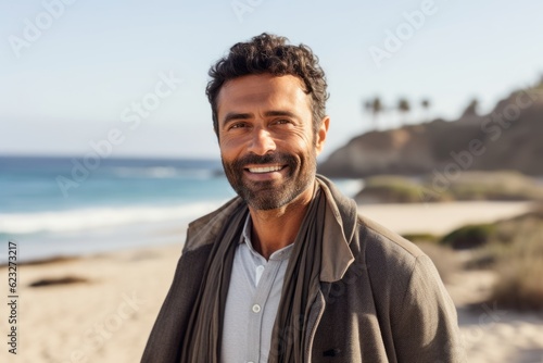 Portrait of a smiling man standing on the beach on a sunny day