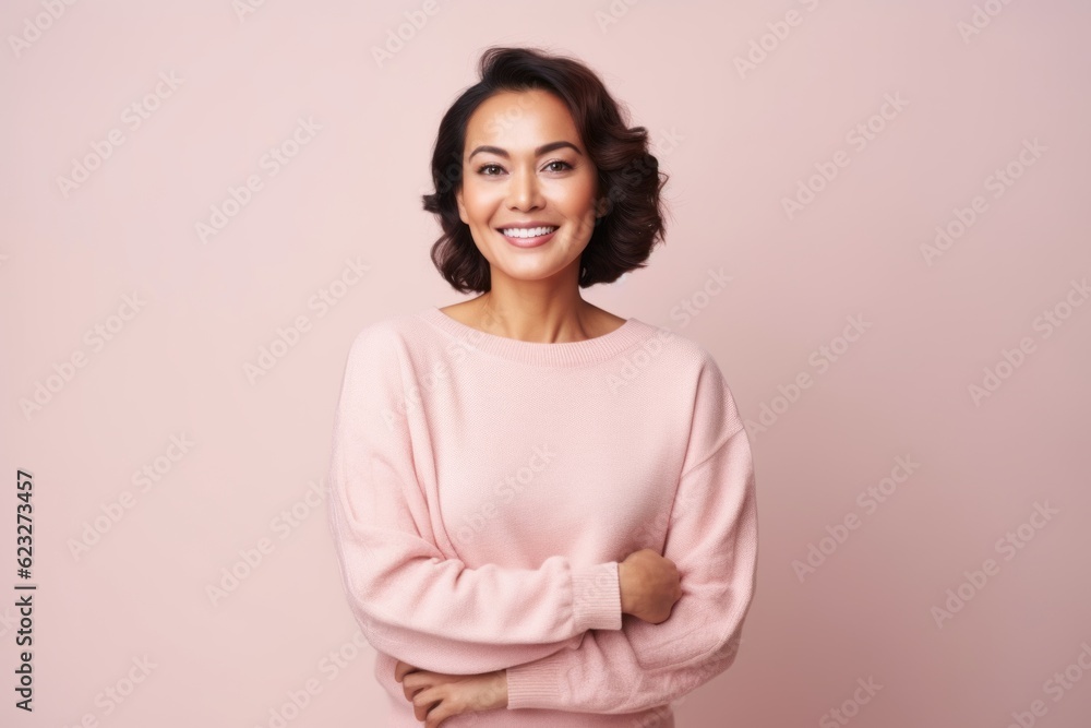 Portrait of a beautiful young woman smiling and looking at camera isolated over pink background Portrait of a beautiful young woman smiling and looking at camera isolated over pink background