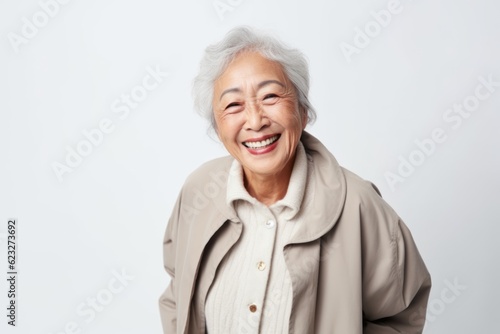 Portrait of smiling senior asian woman isolated on white background.