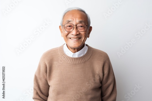 Portrait of happy asian senior man smiling on white background. © Robert MEYNER