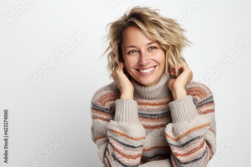 Portrait of a beautiful woman with blond hair in a striped sweater
