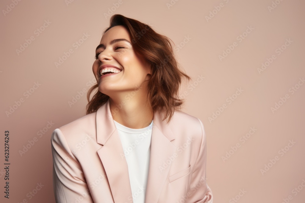 Portrait of a smiling young woman in a pink jacket on a beige background Portrait of a smiling young woman in a pink jacket on a beige background