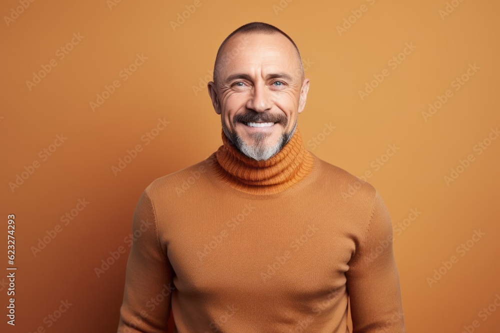 Portrait of a smiling mature man in an orange turtleneck Portrait of a smiling mature man in an orange turtleneck
