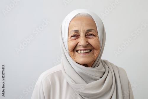 Portrait of a smiling senior muslim woman wearing a headscarf