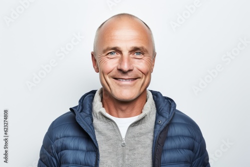 Portrait of a smiling mature man standing isolated on a white background