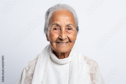 Portrait of a senior asian woman smiling on white background.