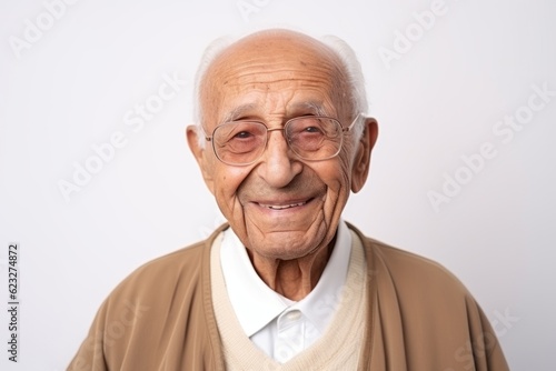 Old asian man wearing eyeglasses and smiling on white background