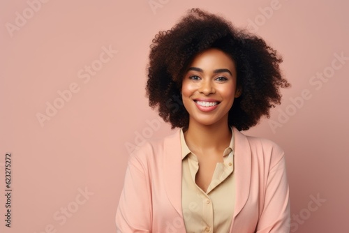 smiling african american woman in pink suit on pink background