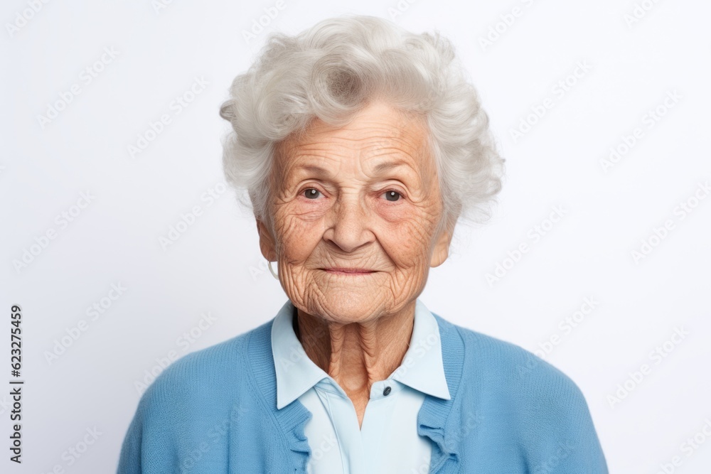 Portrait of a smiling senior woman looking at camera over white background Portrait of a smiling senior woman looking at camera over white background
