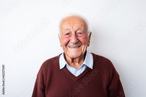 Portrait of a smiling senior man on white background. Elderly people © Anne Schaum