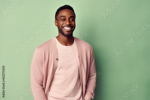 Medium shot portrait photography of a pleased Nigerian man in his 30s wearing a chic cardigan against a pastel or soft colors background 