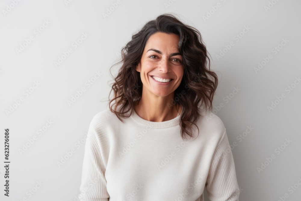 Portrait of a smiling young woman looking at camera over white background Portrait of a smiling young woman looking at camera over white background