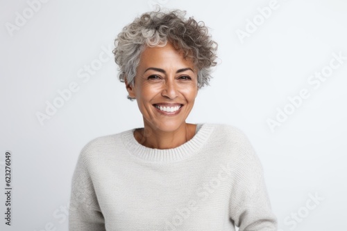 Portrait of a happy mature woman looking at camera over white background
