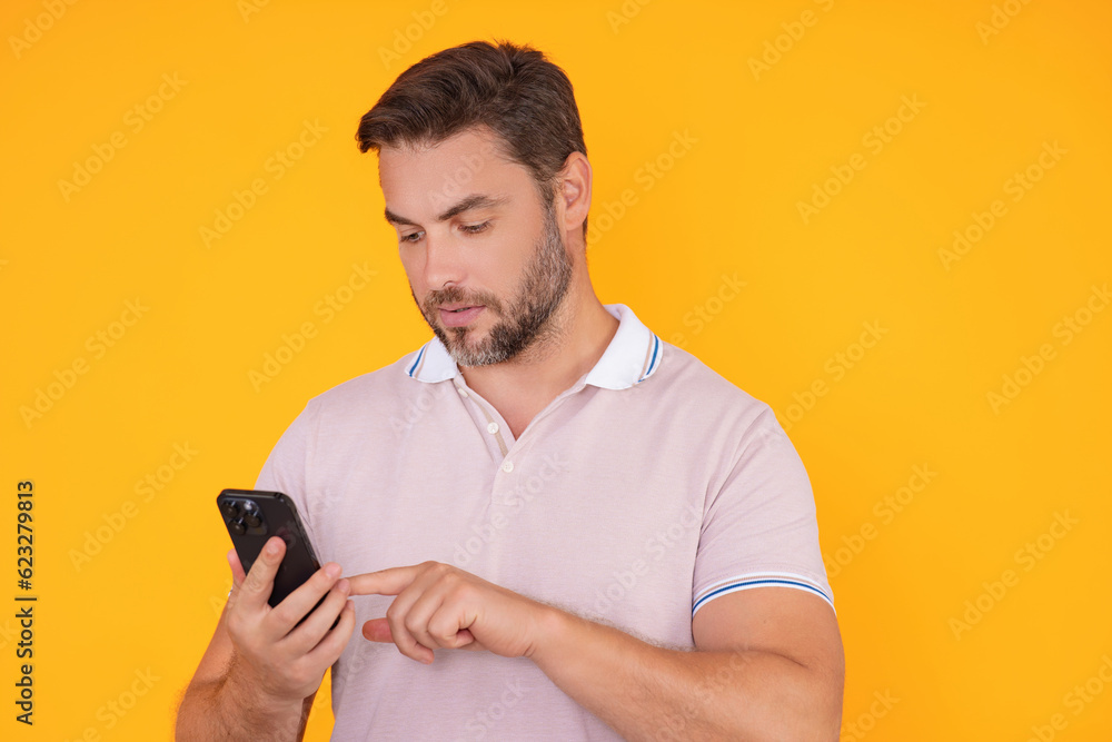 European business man watching on mobile phone. Handsome man wearing formal wear using smart phone, type sms message. Social network. Handsome businessman using mobile phone, talking on phone. European business man watching on mobile phone. Handsome man wearing formal wear using smart phone, type sms message. Social network. Handsome businessman using mobile phone, talking on phone.