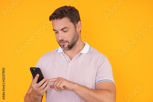 European business man watching on mobile phone. Handsome man wearing formal wear using smart phone, type sms message. Social network. Handsome businessman using mobile phone, talking on phone.