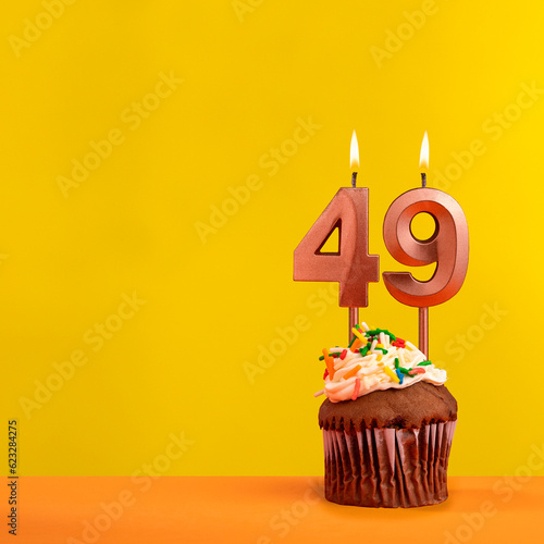 Number 49 birthday candle - Celebration on yellow background