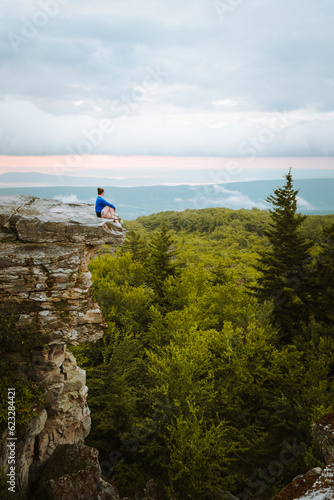 Woman sitting on a rock's edge at Bear Rocks Preserve in the Dolly Sods Wilderness, West Virginia photo