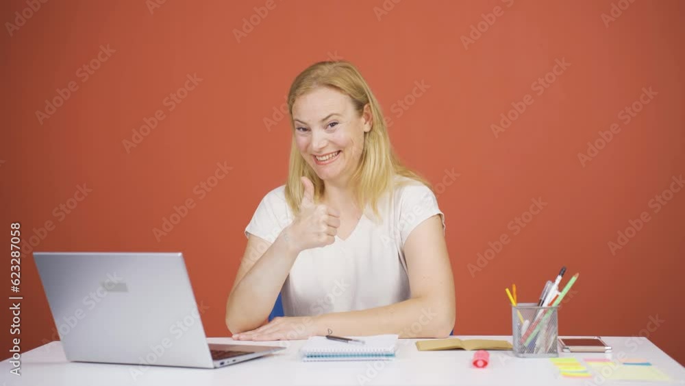 Woman looking at laptop making positive gesture. Woman looking at laptop making positive gesture.