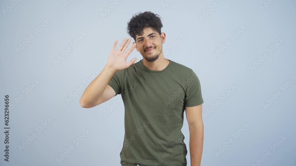Happy man waving at camera. Happy man waving at camera.