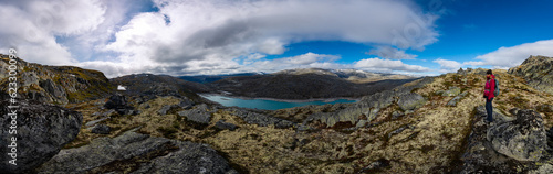 Visiting Norway Hiker admires Skalavatnet Lake Suldal, Norway Panorama