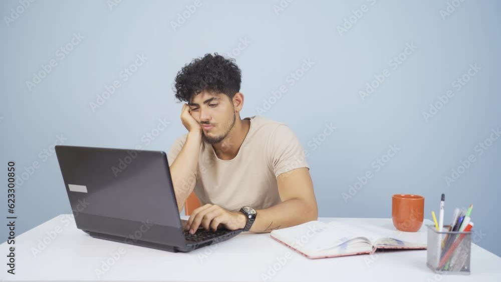 Man looking at laptop is unmotivated and bored. Man looking at laptop is unmotivated and bored.