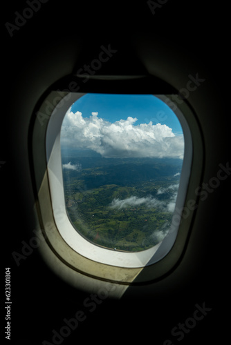 Dark Airplane Window Frame with View of Clouds Over Costa Rica Jungle at Mid-Day