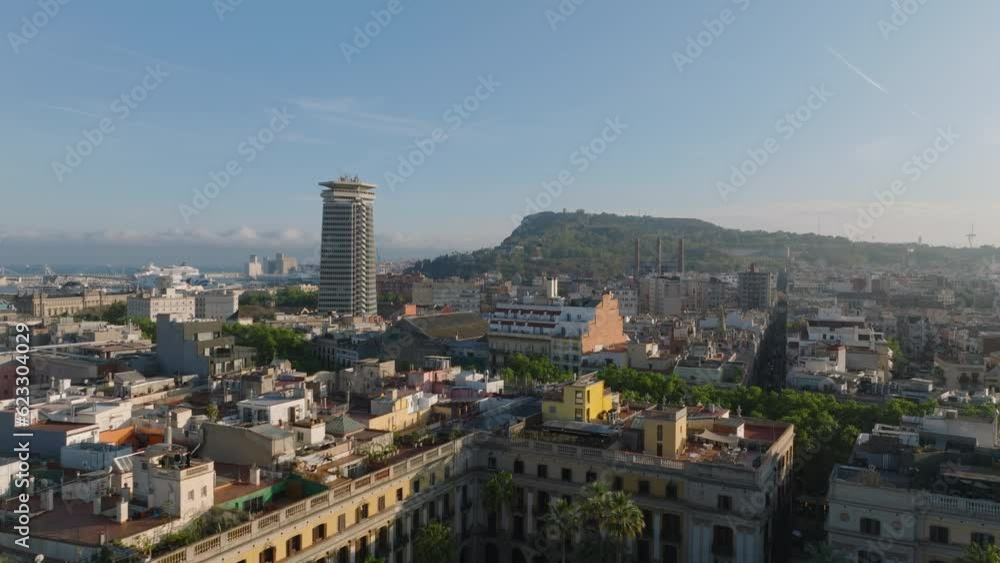 Fly above streets and buildings in old town quarter. Rooftop terraces on palaces around Placa Reial. Barcelona, Spain Fly above streets and buildings in old town quarter. Rooftop terraces on palaces around Placa Reial. Barcelona, Spain