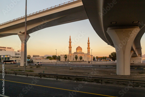 View at sunset from the window of a tourist bus on the Al Khair Masjid mosque and other architecture of the city of Dubai, United Arab Emirates photo