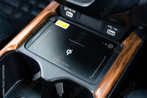 Wireless mobile charger in the modern car. Portable wireless car charger for smartphone. photo