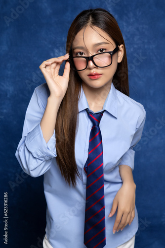 Beautiful Asian woman in school uniform taking a photo of yearbook trend. American yearbook trend popular portrait photography style in Asia. photo