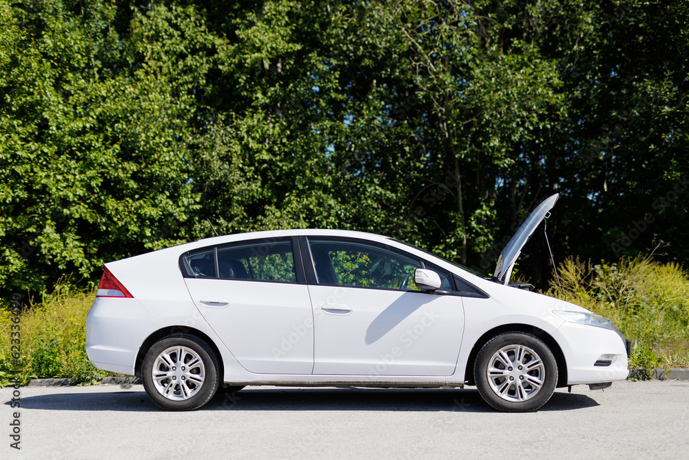 Side view of a car with open hood