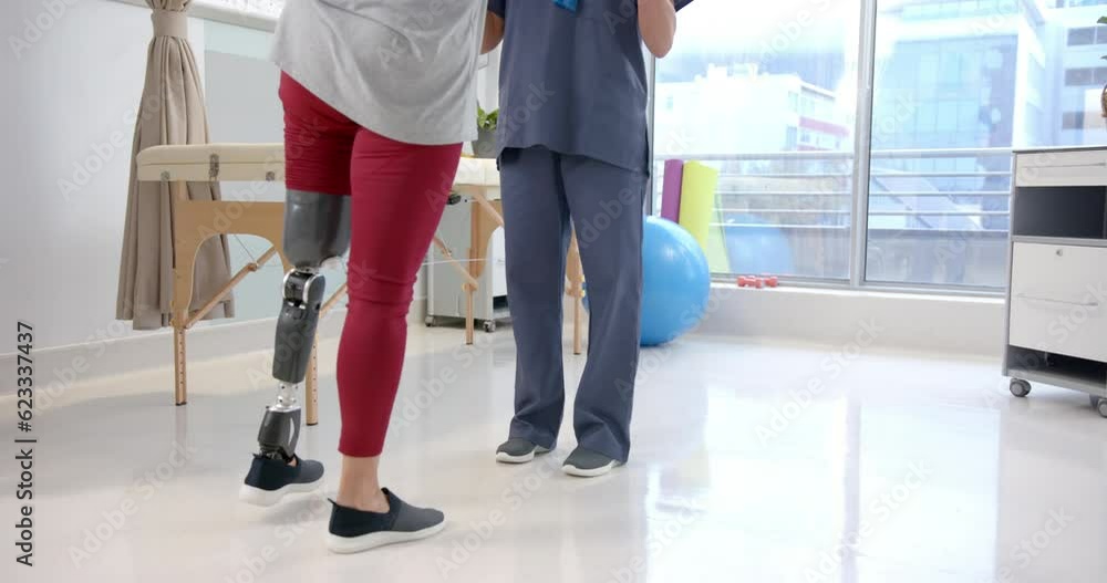 Caucasian female physiotherapist and female senior patient with prosthetic leg exercising Caucasian female physiotherapist and female senior patient with prosthetic leg exercising