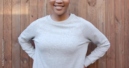 Midsection of happy african american woman in grey long sleeve sweatshirt, copy space, slow motion photo