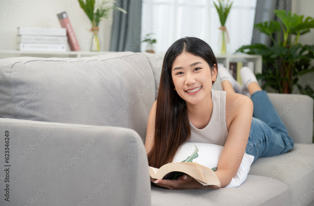 Asian woman happy smile Beautiful Asian woman relaxing reading book in bedroom at home. home relaxation concept Asian woman happy smile Beautiful Asian woman relaxing reading book in bedroom at home. home relaxation concept
