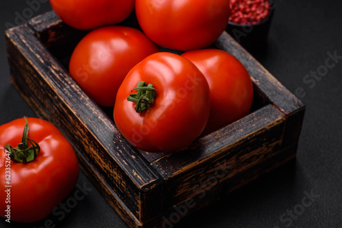 Delicious fresh juicy tomatoes on a dark concrete background