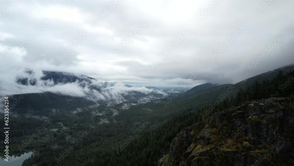 Aerial drone view from Rattlesnake ridge seattle. You can see the river, the mountains and the green pines. Majestic nature scene. Panning. Aerial drone view from Rattlesnake ridge seattle. You can see the river, the mountains and the green pines. Majestic nature scene. Panning.