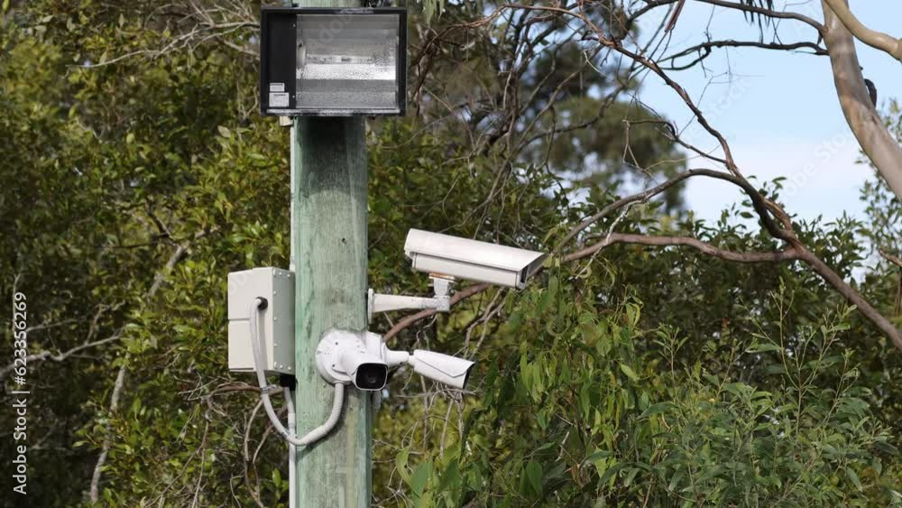 Three Security Cameras Monitoring on a Lamp Post Three Security Cameras Monitoring on a Lamp Post