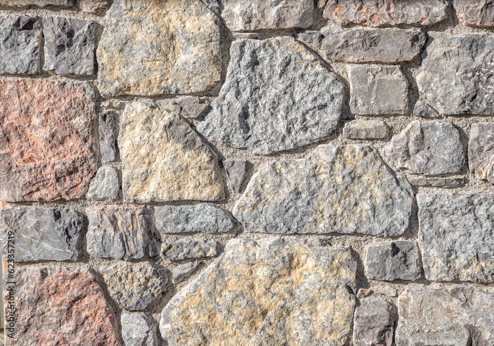 Fototapeta premium closeup of a stone wall with irregular blocks