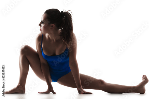 Young woman working out and stretching, isolated on a white background