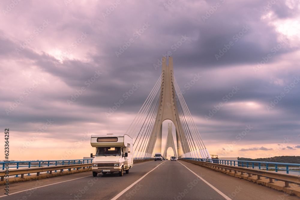 Obraz premium Motorhome driving over the Portimao bridge in the Algarve, Portugal.