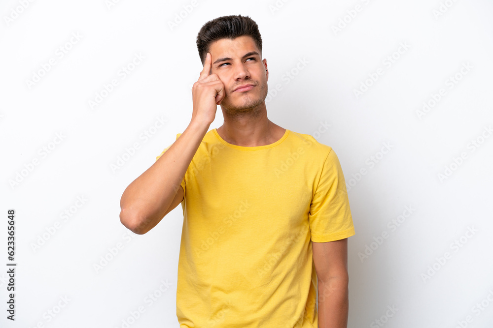 Young caucasian man isolated on white background making the gesture of madness putting finger on the head Young caucasian man isolated on white background making the gesture of madness putting finger on the head