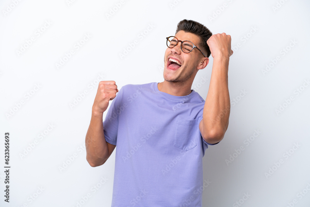 Fototapeta premium Young caucasian man isolated on white background celebrating a victory