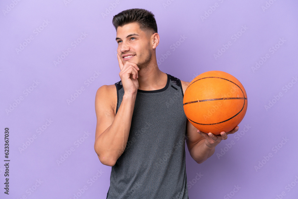 young caucasian woman  basketball player man isolated on purple background thinking an idea while looking up