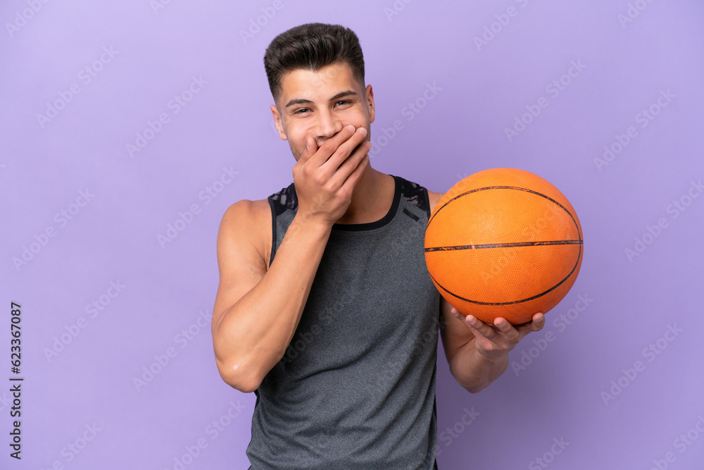 young caucasian woman  basketball player man isolated on purple background happy and smiling covering mouth with hand