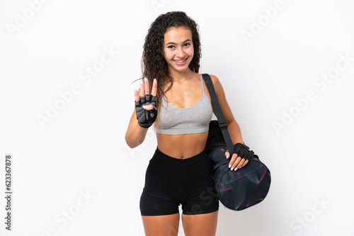 Young sport Arab woman with sport bag isolated on white background happy and counting four with fingers © luismolinero