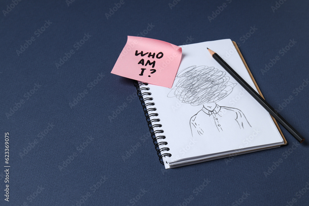 Notepad with pencil drawing and pink note with text on dark blue background, space for text