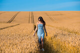 beautiful young woman in golden wheat field