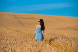 beautiful young woman in golden wheat field