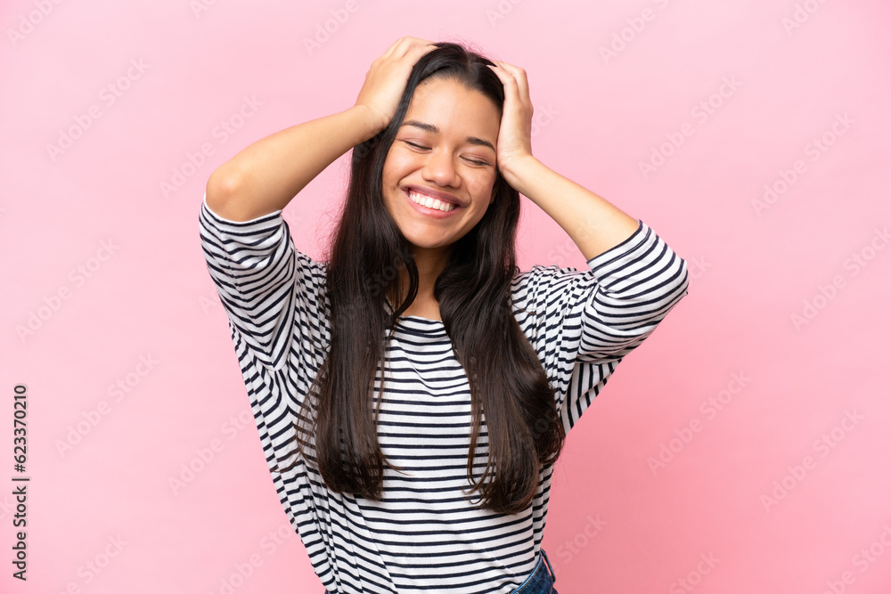 Young Colombian woman isolated on pink background laughing Young Colombian woman isolated on pink background laughing
