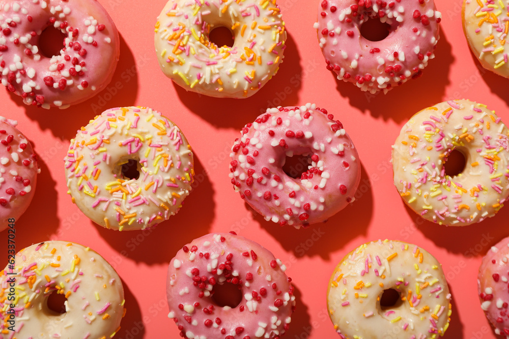 Pink and white donuts on pink background, top view